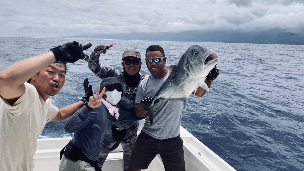 Anglers holding Giant Trevally