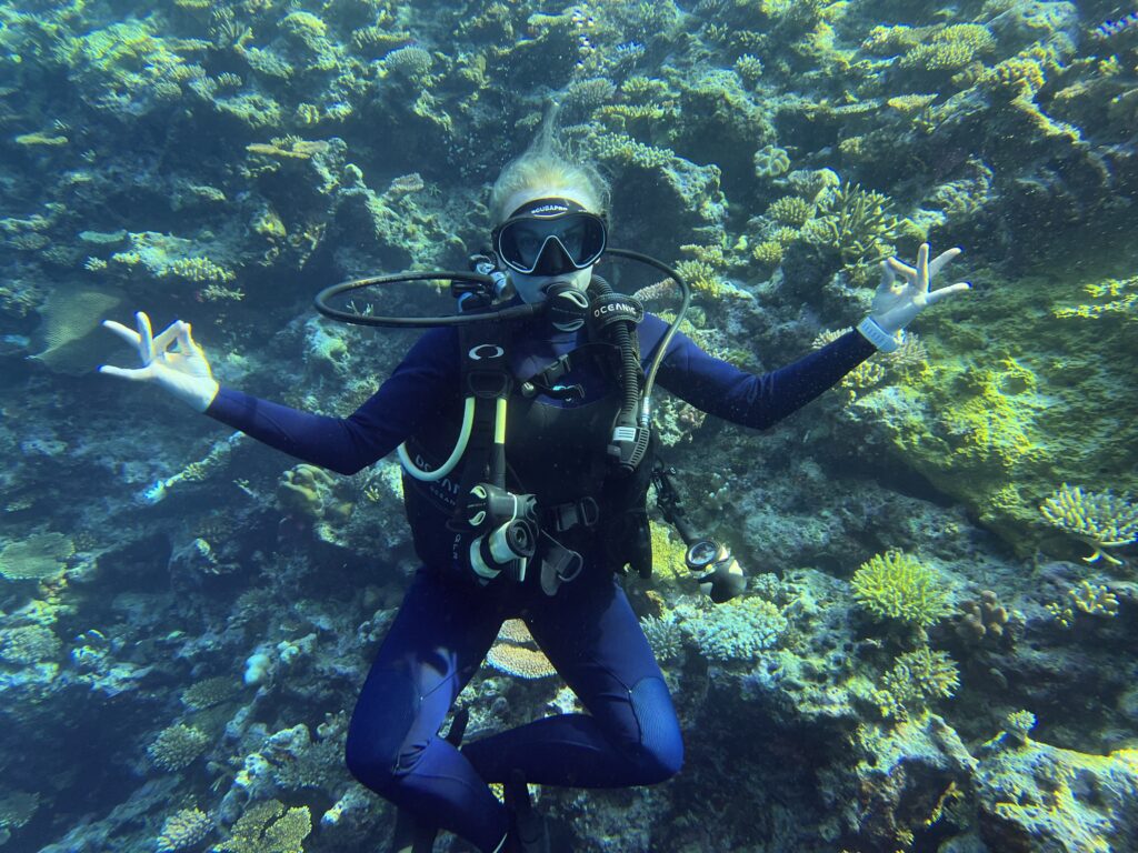 Scuba diver with relaxed pose underwater